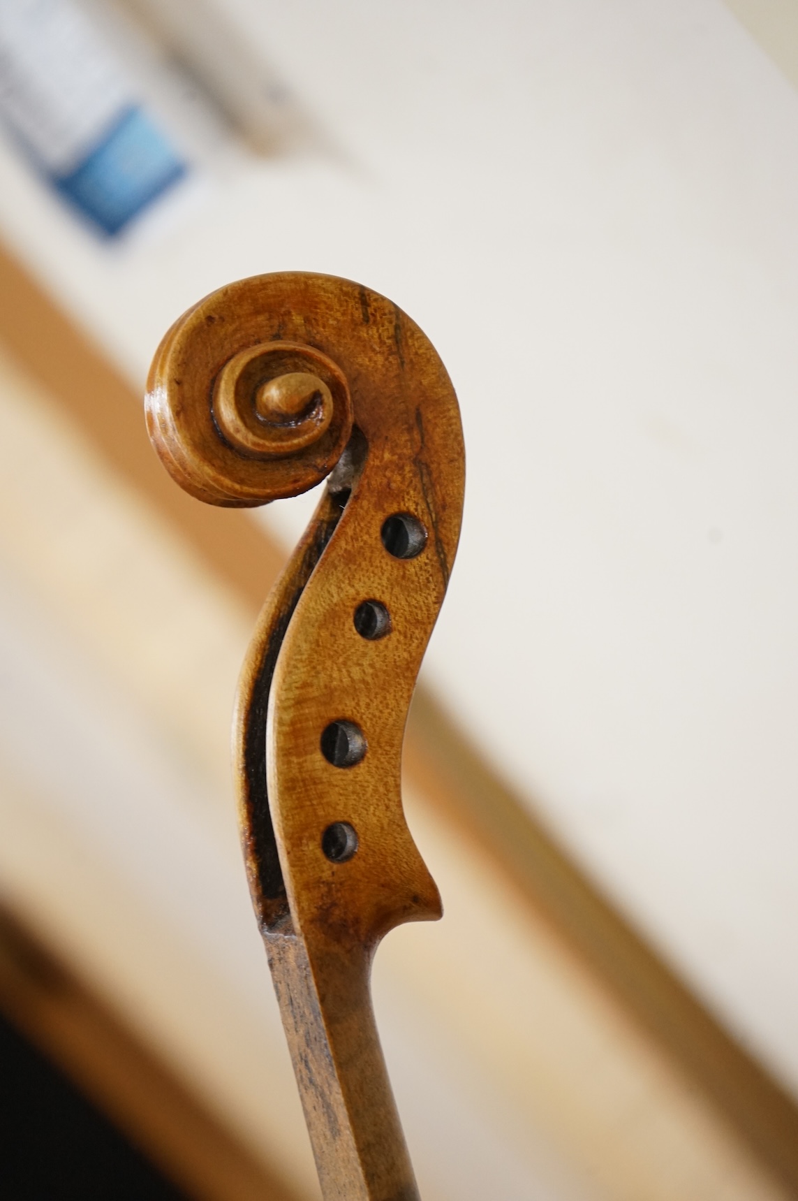 Three violins; a late 19th century German Stradivarius pattern violin, without label, a handmade violin (a.f.), with sound post crack, broken and repaired scroll, etc. and a Maidstone violin body, varnish stripped from t